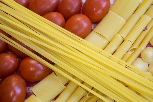 raw assorted pasta with fresh ripe tomatoes 