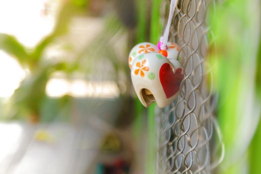 Heart toys on the cage metal net background