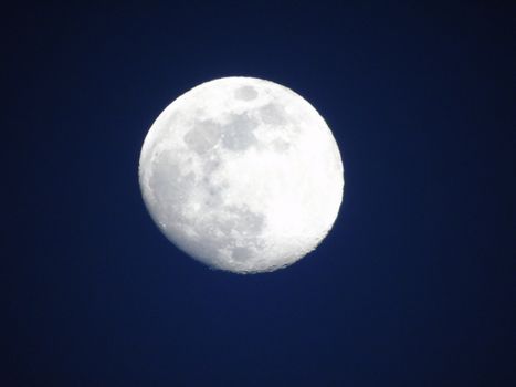 An amazing full moon over the city in spring