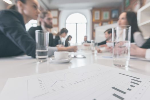 Business people at meeting in office discuss financial charts