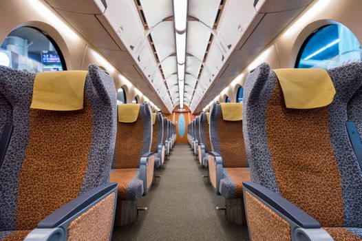 Interior of a train with empty seats. Modern train seats.