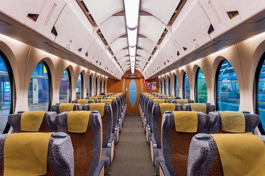 Interior of a train with empty seats. Modern train seats.