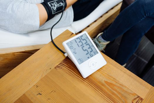 View of an caucasian nurse taking the blood pressure of a male patient