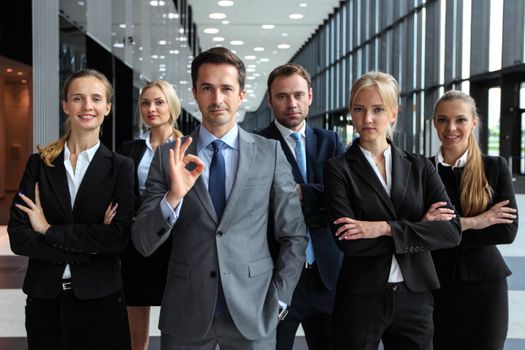Portrait of successful business people team standing together in modern office building