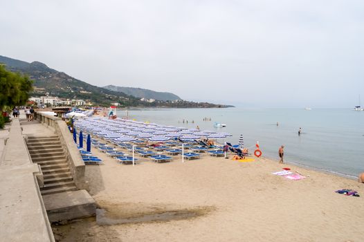 View of the beach of Cefalu with the old city in the background in the north of Sicily in Italy