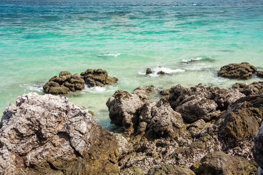 Stone In Green Sea With Wave