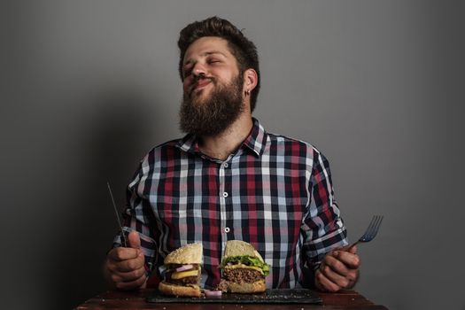 Man eating fresh self made burger close up