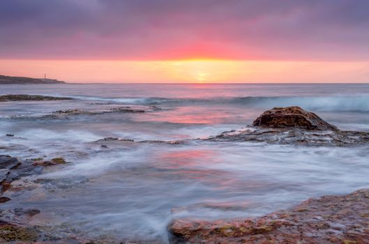 Beautiful sunrise over the ocean, taken from the rocky reef at Boat Harbour