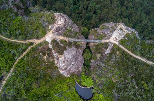 Views down onto a newly completed Buttenshaw Bridge,  a challenging task of constructing a 14 metre steel bridge across a deep rock chasm on the edge of a sheer sandstone escarpment was made possible with a $78,000 grant.  Both cliffs have fenced viewing platforms and a bench seat to relax.