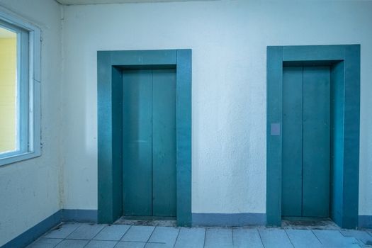 empty modern elevator or lift with closed metal doors