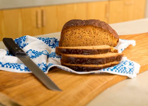 Slices of gluten-free bread above a wooden board 
