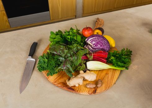 Several vegetables on top of a wooden board. Ingredients for detox diet. 