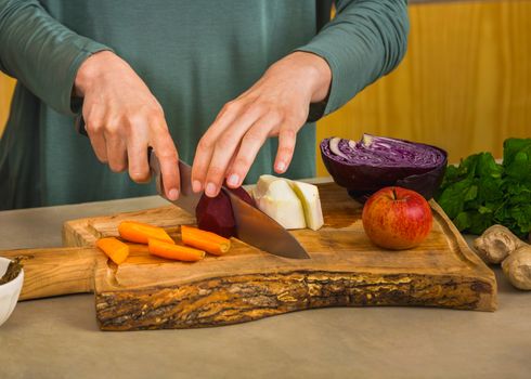 Several vegetables on top of a wooden board. Ingredients for detox juice.
