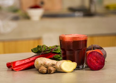 Glass jar of red juice, a detox beverage.   