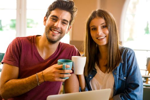 Friends studying together and making a toast with coffee