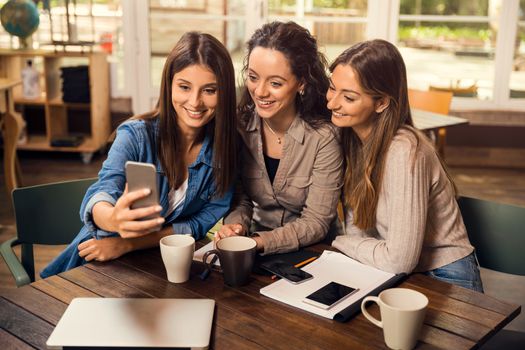 Groups of female firends making a selfie during a pause on the studies