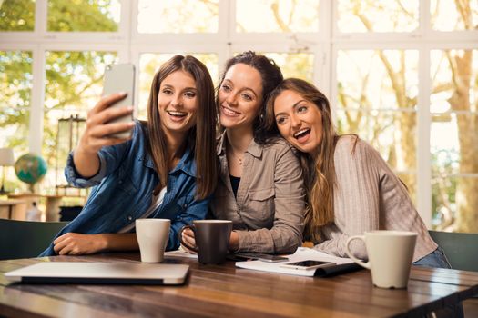 Groups of female firends making a selfie during a pause on the studies