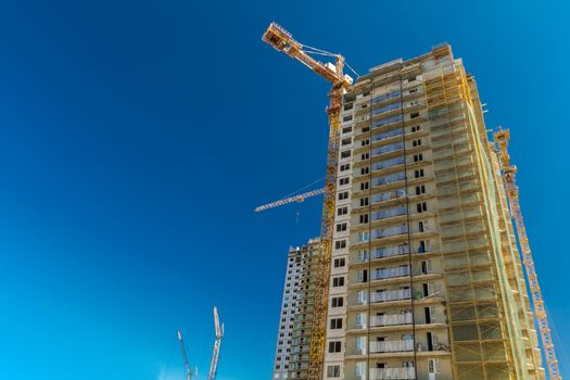 Construction of new real estate apartment buildings over blue sky