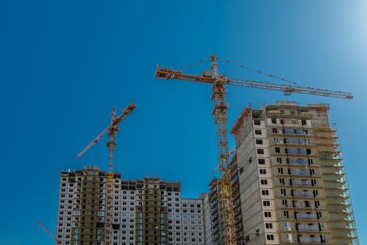 Construction of new real estate apartment buildings over blue sky