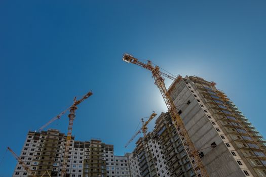 Construction of new real estate apartment buildings over blue sky