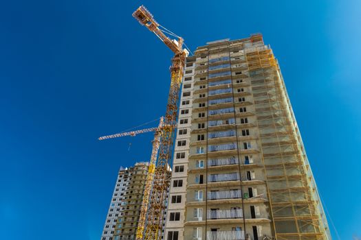 Construction of new real estate apartment buildings over blue sky