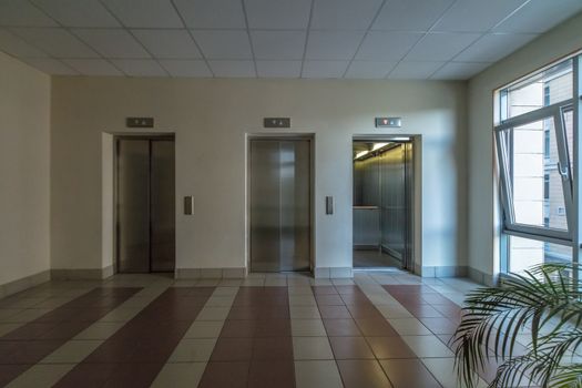 empty modern elevator or lift with closed metal doors