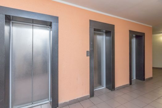 empty modern elevator or lift with closed metal doors