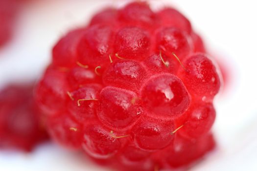 A background of ripe red raspberry with milk