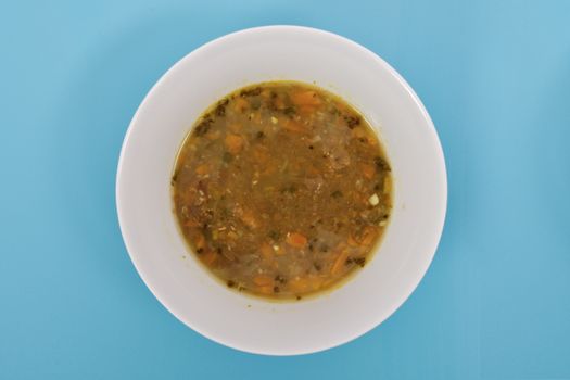 Lentil soup with carrot on a blue background