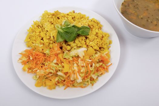 Baked Bulgar with cauliflower and vegetable salad on a white background