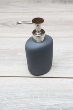 liquid soap dispenser on a wooden table