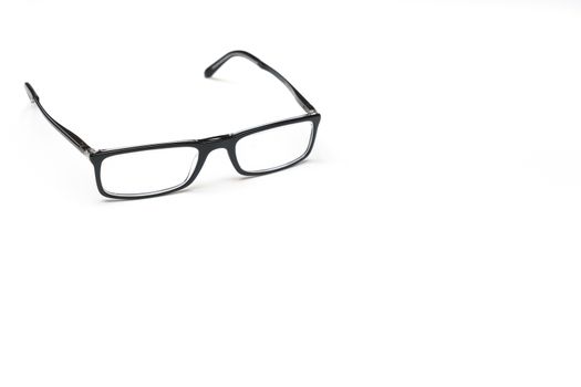 a pair of eyeglasses on a white surface