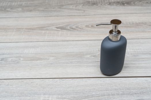 liquid soap dispenser on a wooden table