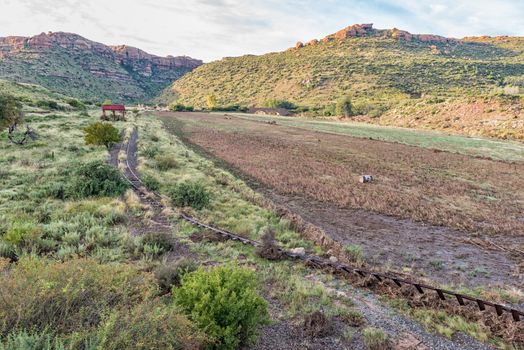 The flood damaged third railway reverse near Lady Grey in the Eastern Cape Province of South Africa. The historic De Wet Bridge is visible in the back