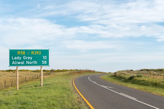 The landscape, with distance sign, on the road between Lady Grey and Barkly East in the Eastern Cape Province