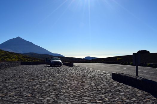 Road travel concept with car and Teide Peak in Tenerife, Canary Islands, Spain