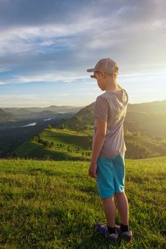 Young explorer at the sunset in Altai mountains