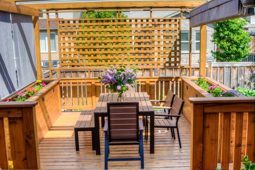 A bouquet of lilac on a beautiful, wooden veranda on a warm May day