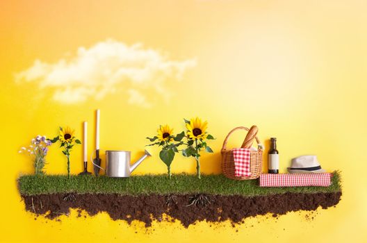 Summer picnic basket on grass patch with sunflowers