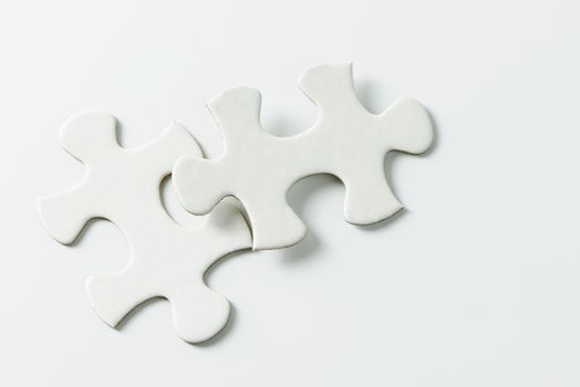 Two pieces of blank white jigsaw puzzle isolated on white background for business conceptual