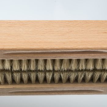 a clothes brush  on a mirror