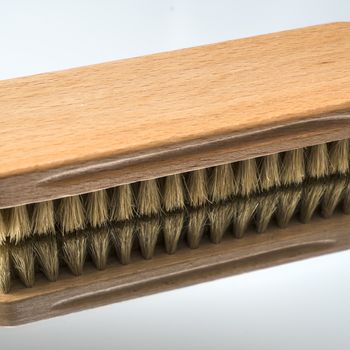 a clothes brush  on a mirror