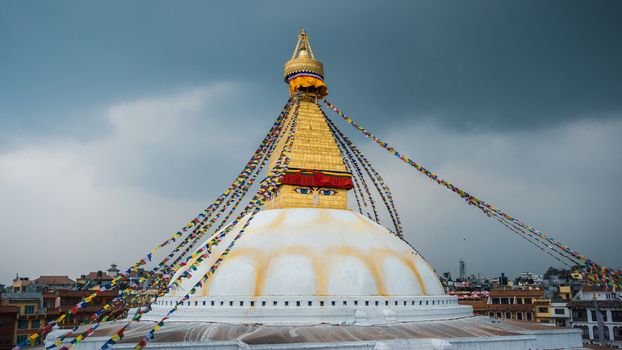 Boudhanath stupa in Kathmandu, Nepal. Stormy clouds in the background.