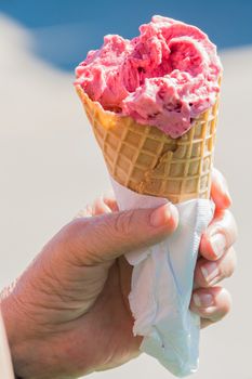 Fruit ice cream on a summer hot day, that quickly melts in the sun