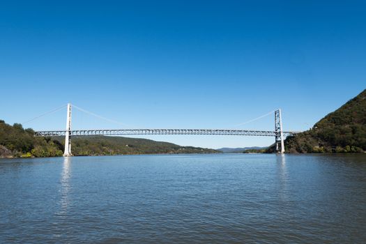 The Bear Mountain Bridge is a toll suspension bridge in New York State, carrying US 6/US 202 across the Hudson River between Rockland/Orange Counties and Westchester/Putnam Counties. From the time of its completion in 1924, it held the record for the longest suspension bridge in the world for 19 months, until it was surpassed by the Benjamin Franklin Bridge in Philadelphia.