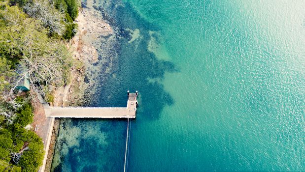 A lovely jetty popular with fisherman juts out from the rocky shore into the pristine waters of Sydney coast