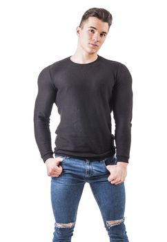 Handsome young muscular man looking at camera in studio shot, with arms crossed on chest, isolated on white background