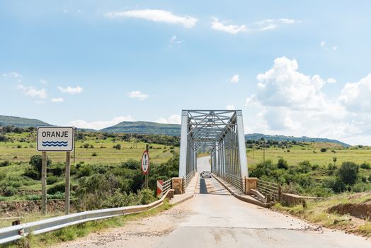 A vehicle is crossing the single lane bridge over the Orange River between Sterkspruit and Zastron