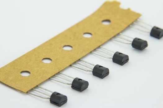 The old transistors with reel package on the white background