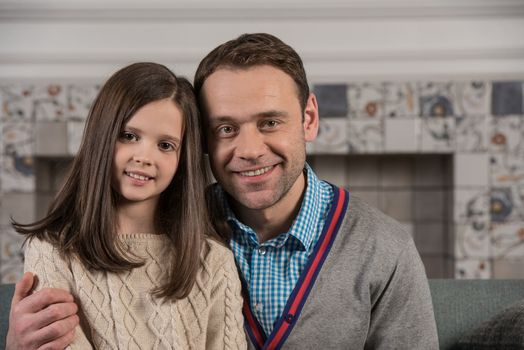 Family portrait of happy father and his daughter at home